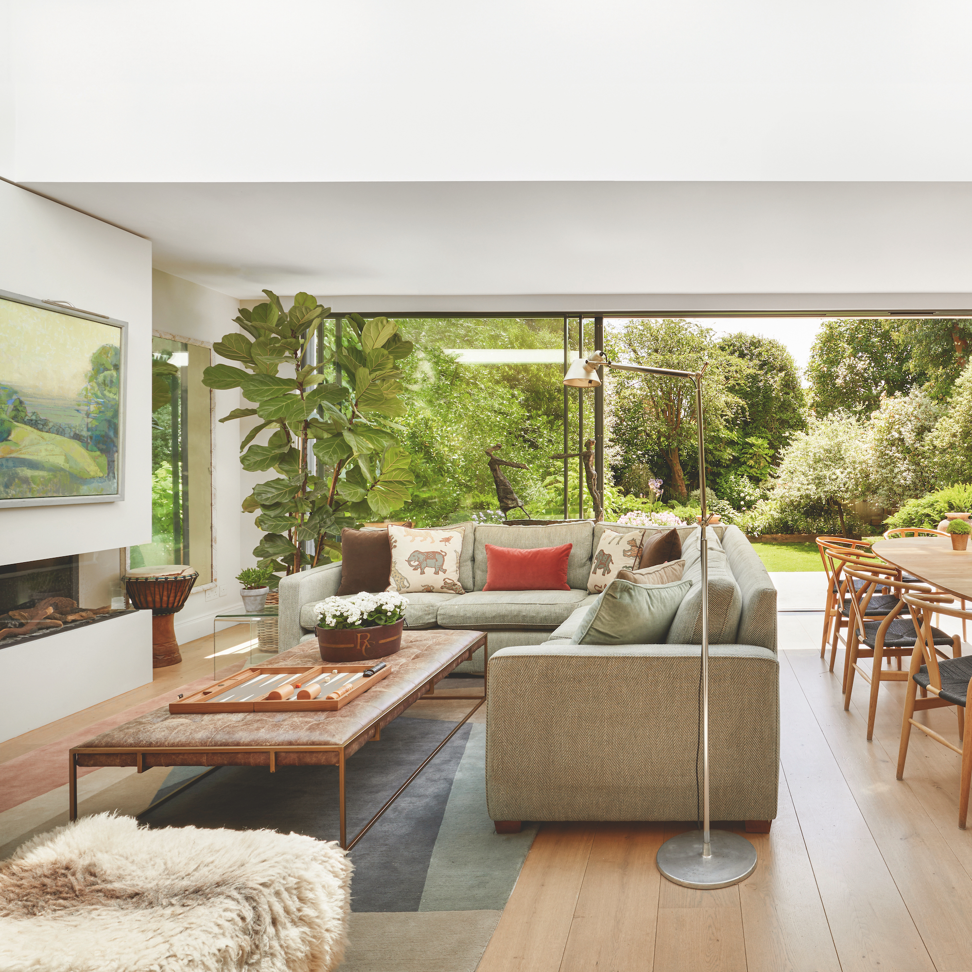 grey corner sofa in contemporary living room with sliding glass doors to garden
