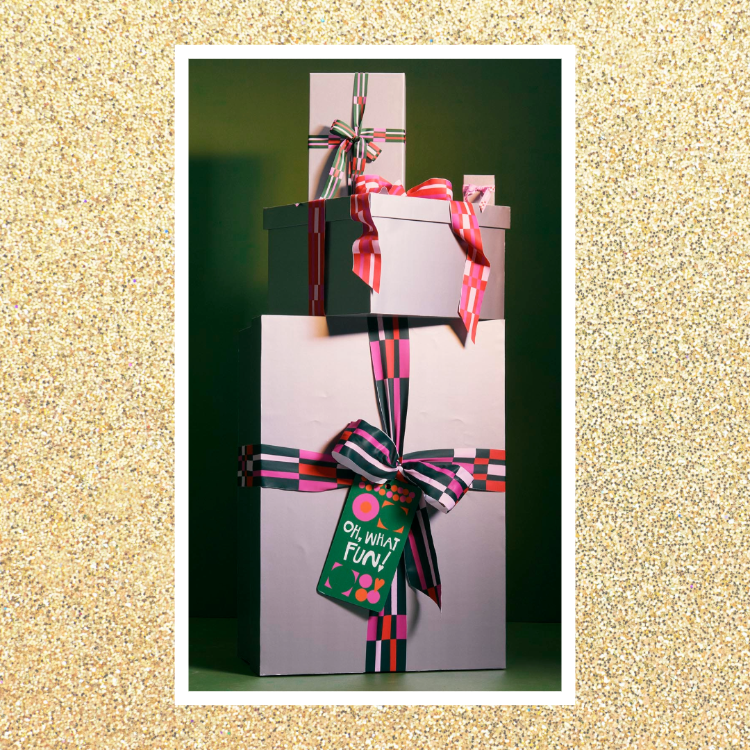 Gold glitter background overlaid with image of wrapped presents