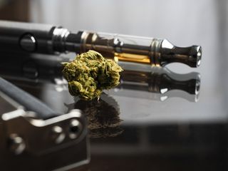 An e-cigarette next to cannabis.
