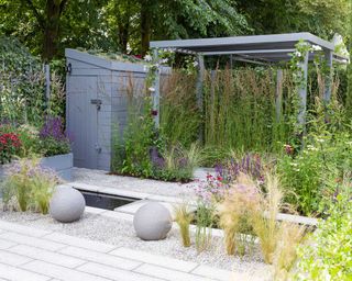 Garden at Hampton Court Flower Show 2018 with grasses and pergola