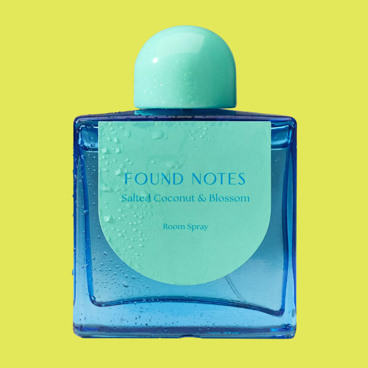 A blue glass room spray bottle