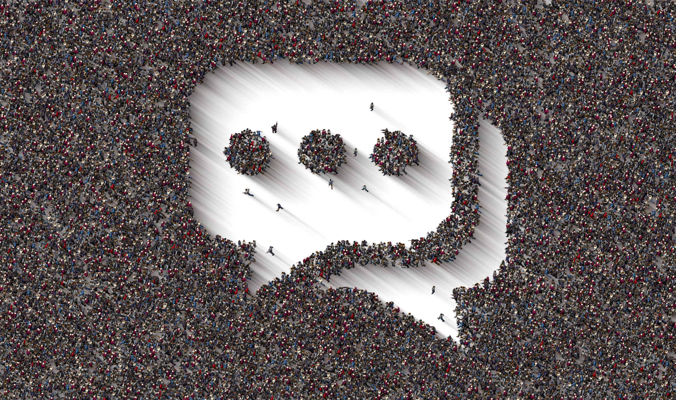 A large crowd of people forming a speech bubble symbol.