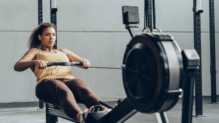 One woman works out on one of the best rowing machines