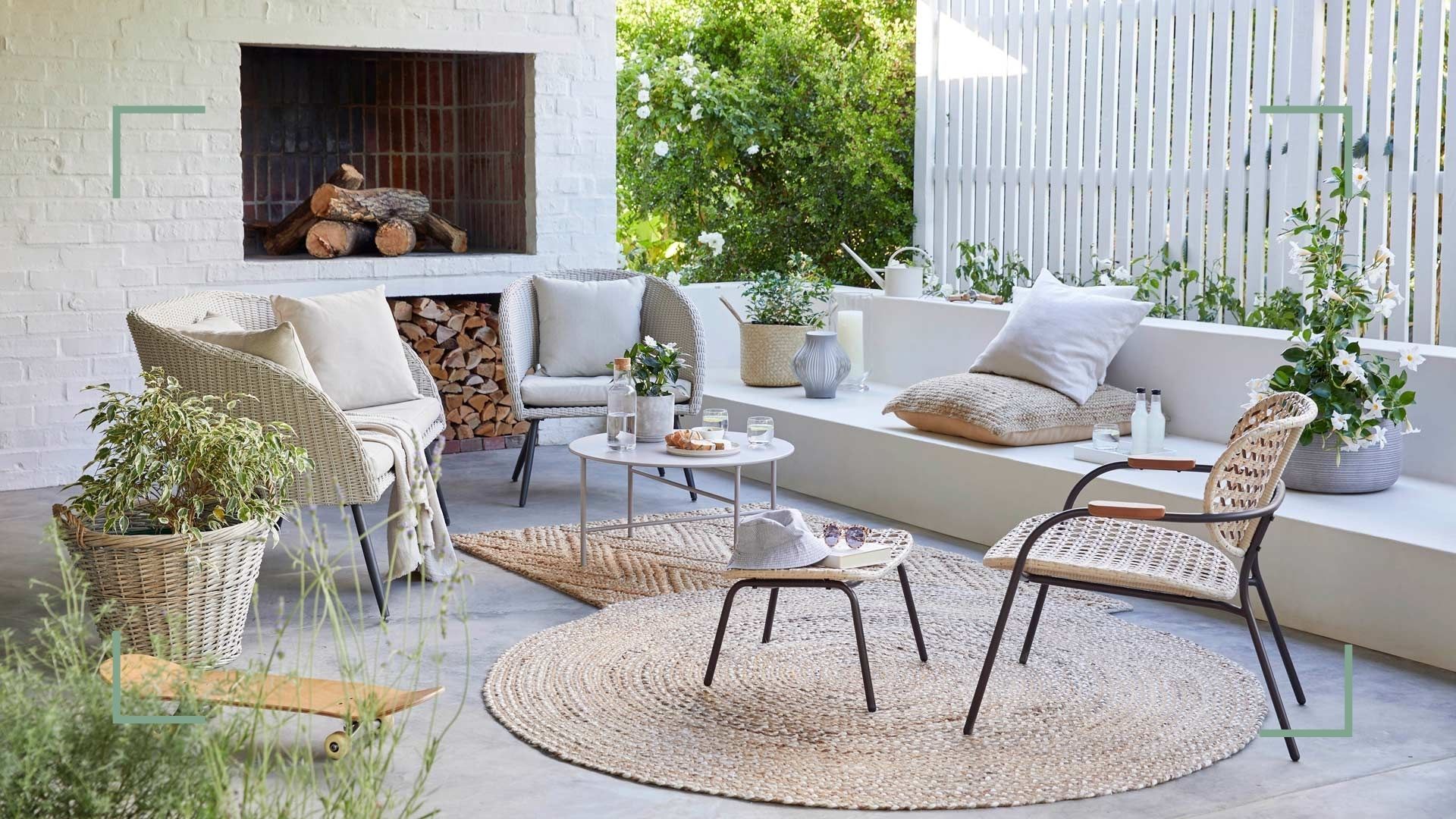 outdoor living room with comfortable outdoor sofas and chairs with outdoor rugs and outdoor coffee table