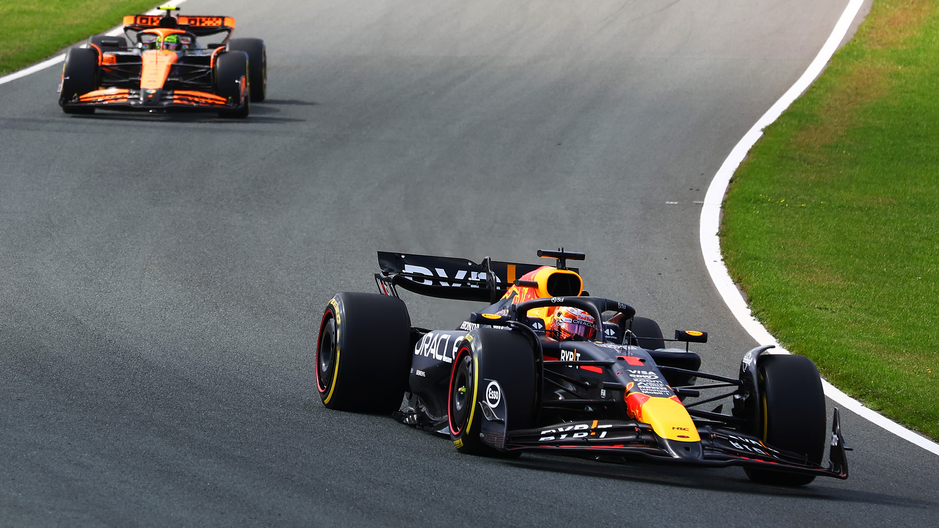 Max Verstappen of the Netherlands driving the (1) Oracle Red Bull Racing RB20 leads Lando Norris of Great Britain driving the (4) McLaren MCL38 Mercedes at the start during the F1 Grand Prix of Netherlands at Circuit Zandvoort on August 25, 2024 in Zandvoort, Netherlands.