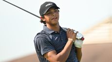 Charlie Woods observes a shot