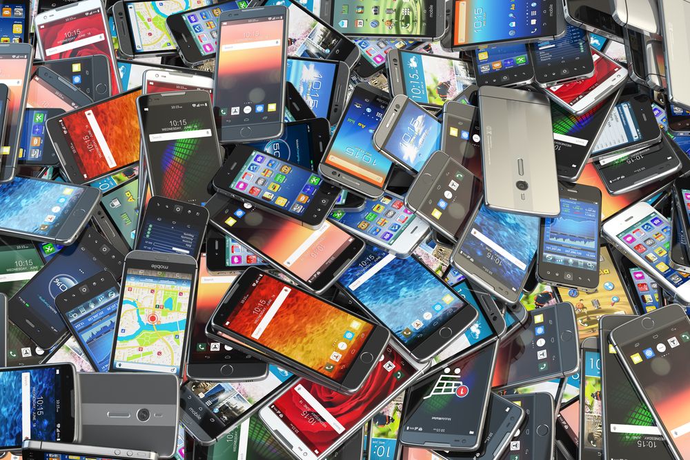 An image of a pile of mobile phones all on top of each other