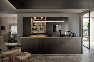 Kitchen with dark cabinetry, island and adjoining seating area