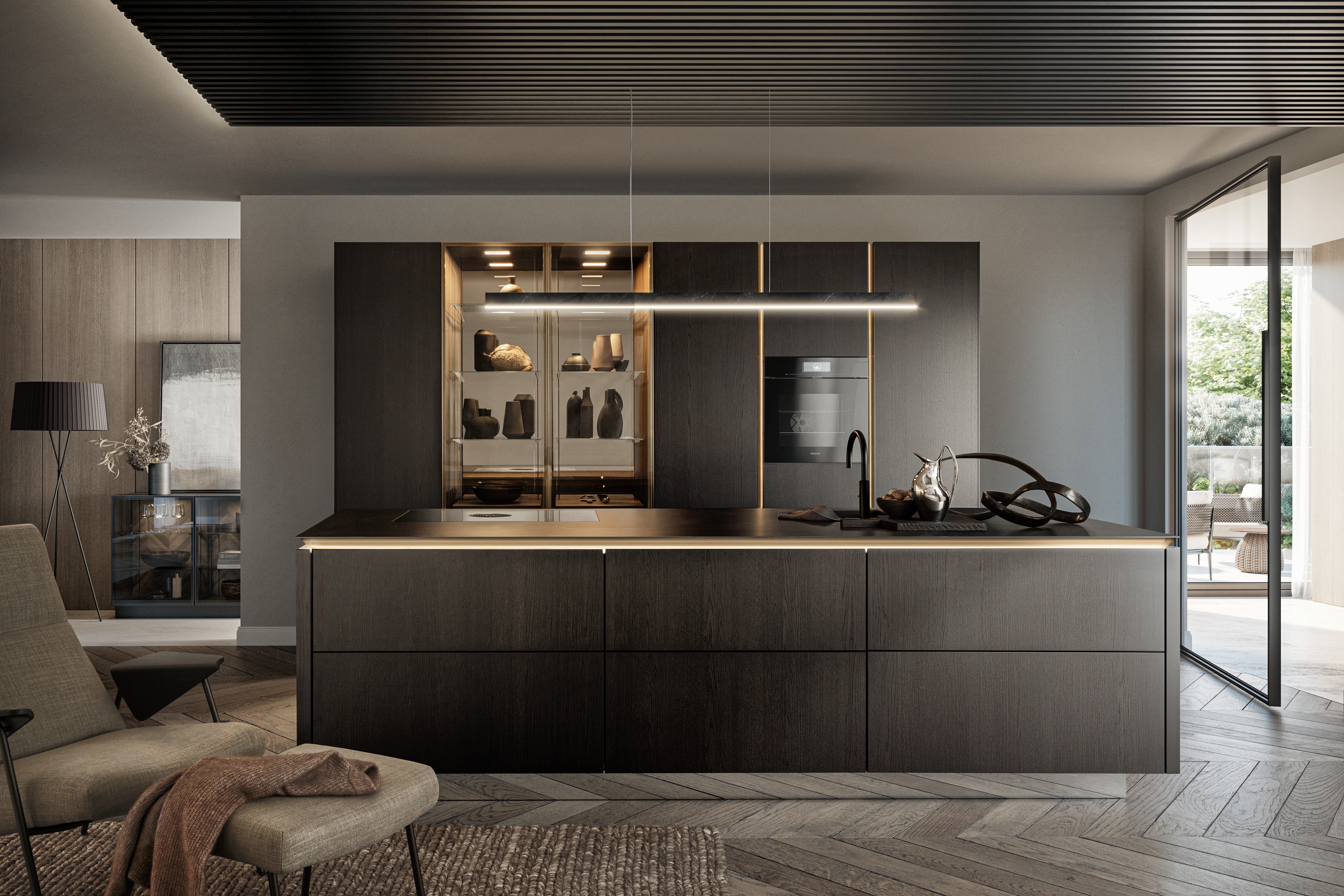 Kitchen with dark cabinetry, island and adjoining seating area