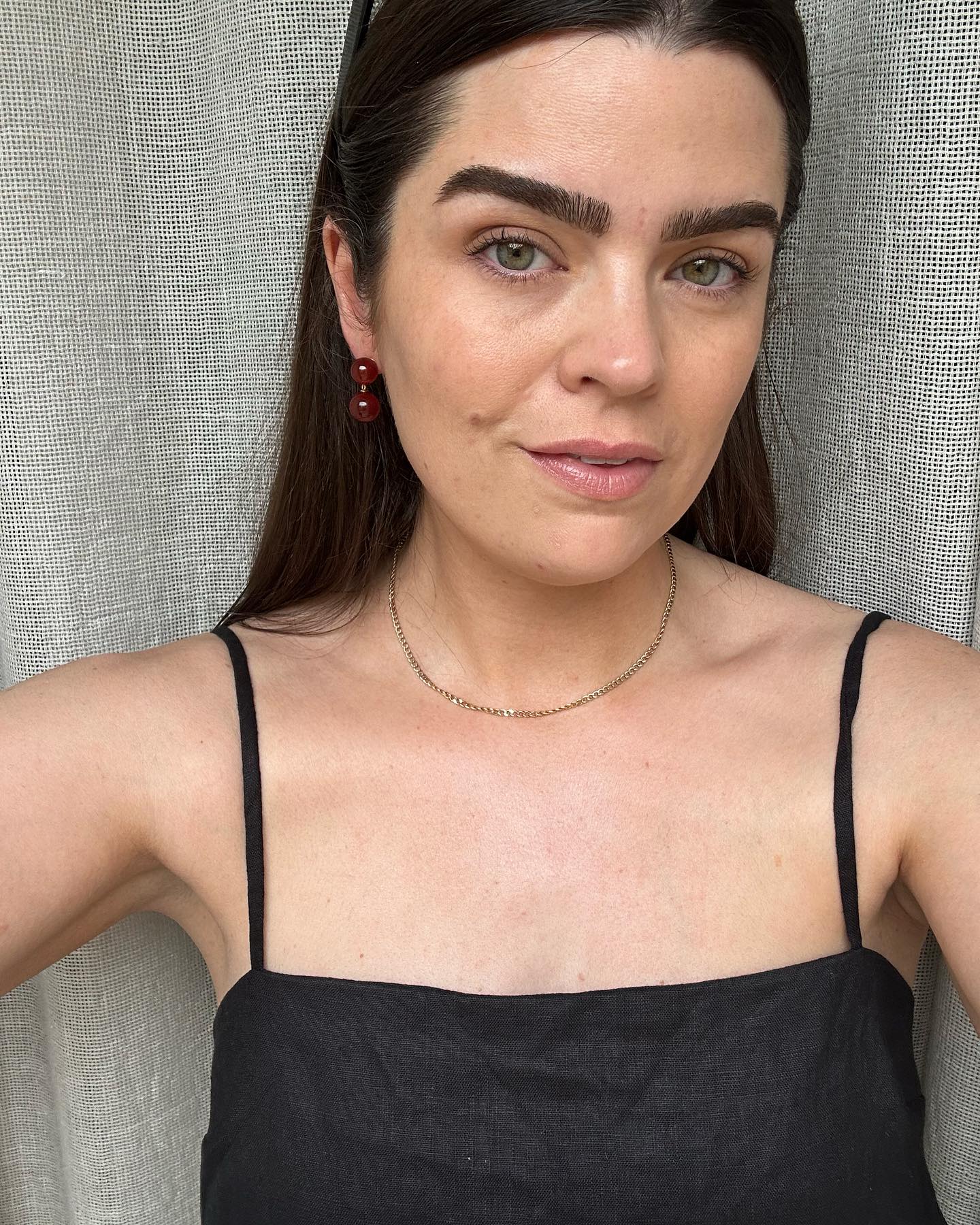 Anna Newton with natural makeup and strappy black cami