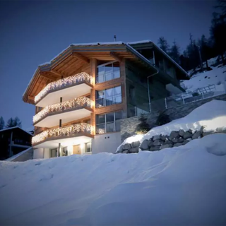 three story wooden house in snow mountain