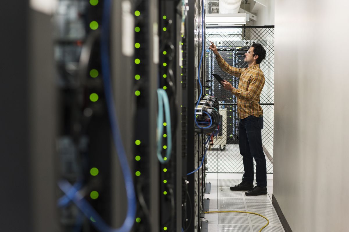 IT worker checking servers in a data center