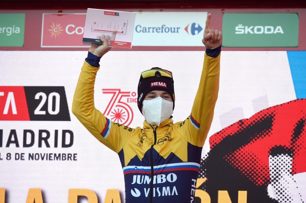 Team Jumbo rider Slovenias Primoz Roglic celebrates on the podium after winning the 13th stage of the 2020 La Vuelta cycling tour of Spain a 337km individual timetrial from Muros to Mirador de Ezaro Dumbria on November 3 2020 Slovenian Primoz Roglic claimed victory in the Vuelta a Espana time trial on today to regain the lead in the overall classification Roglic took back the red jersey from Ecuadors Richard Carapaz while Britains Hugh Carthy sits third ahead of the races climax on November 1 2020 Photo by MIGUEL RIOPA AFP Photo by MIGUEL RIOPAAFP via Getty Images