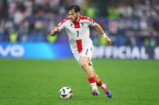 Georgia Euro 2024 squad Khvicha Kvaratskhelia of Georgia runs with the ball during the UEFA EURO 2024 group stage match between Turkiye and Georgia at Football Stadium Dortmund on June 18, 2024 in Dortmund, Germany. (Photo by Lars Baron/Getty Images)