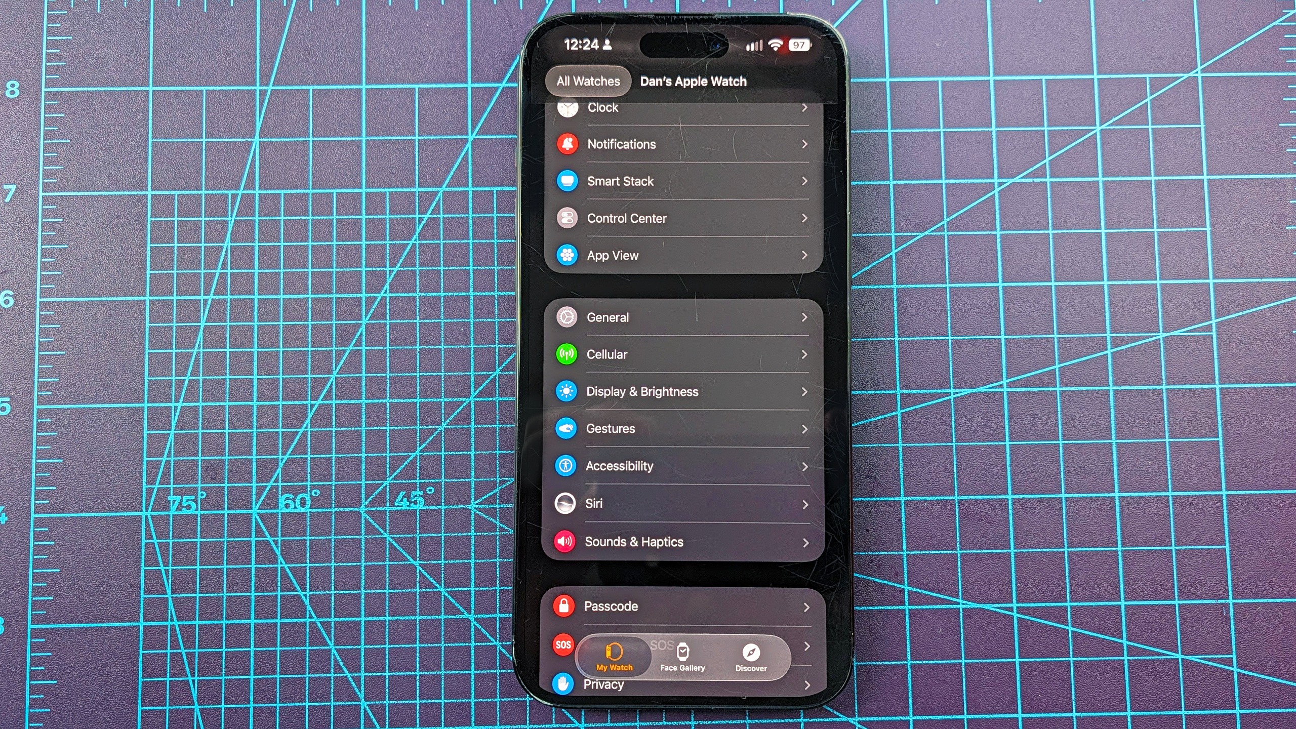 Close-up of an iPhone 16 Plus showing how to add the new step count widget to your Apple Watch's watch face