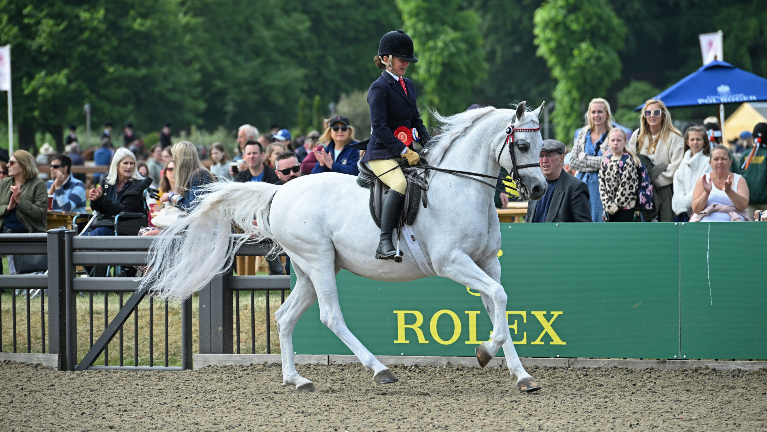 ClareFitch and grey Arab gelding Aja Guiliano canter out of the ring victorious at Royal Windsor