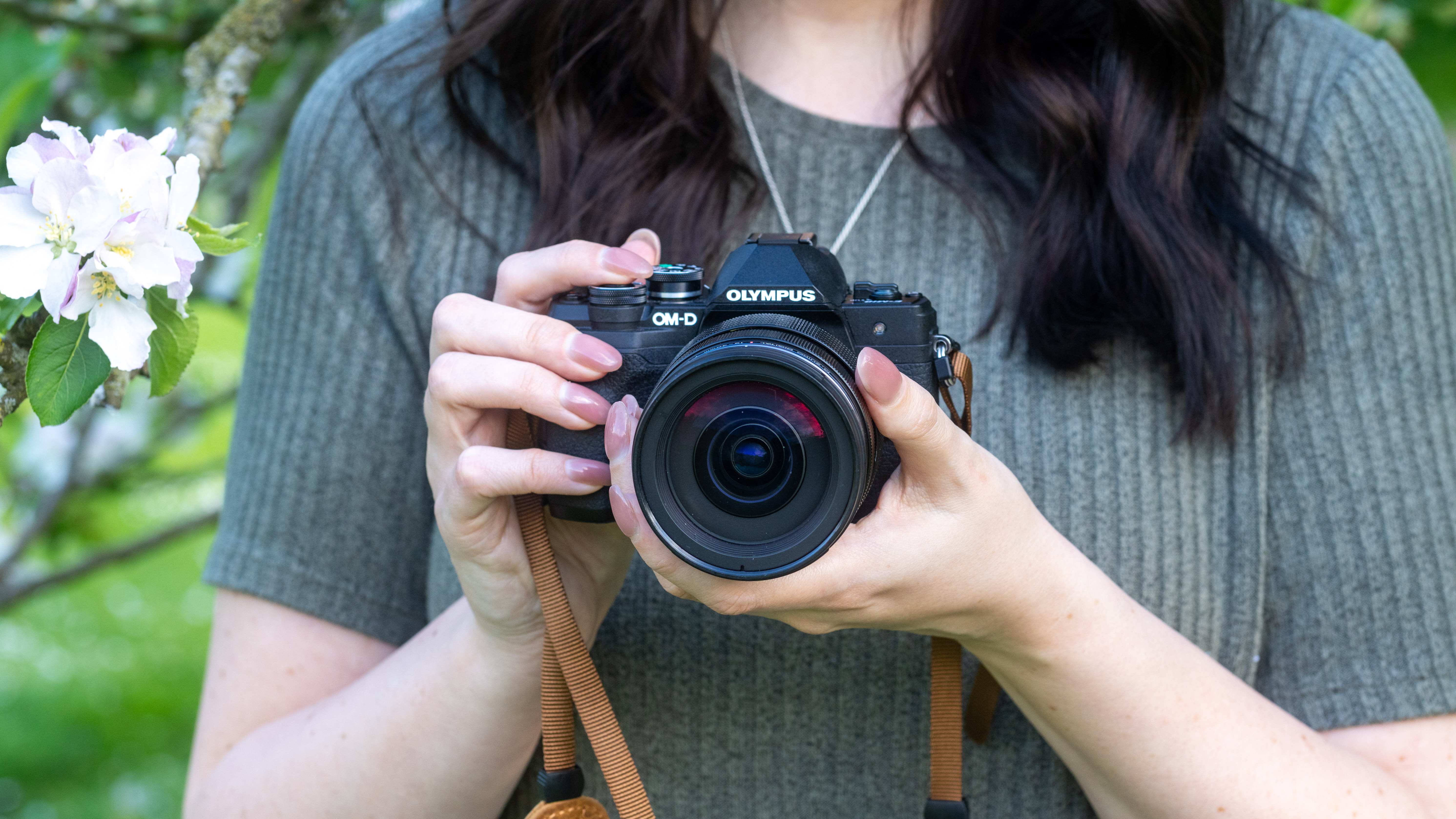 woman holding the Olympus OM-D E-M10 Mark IV