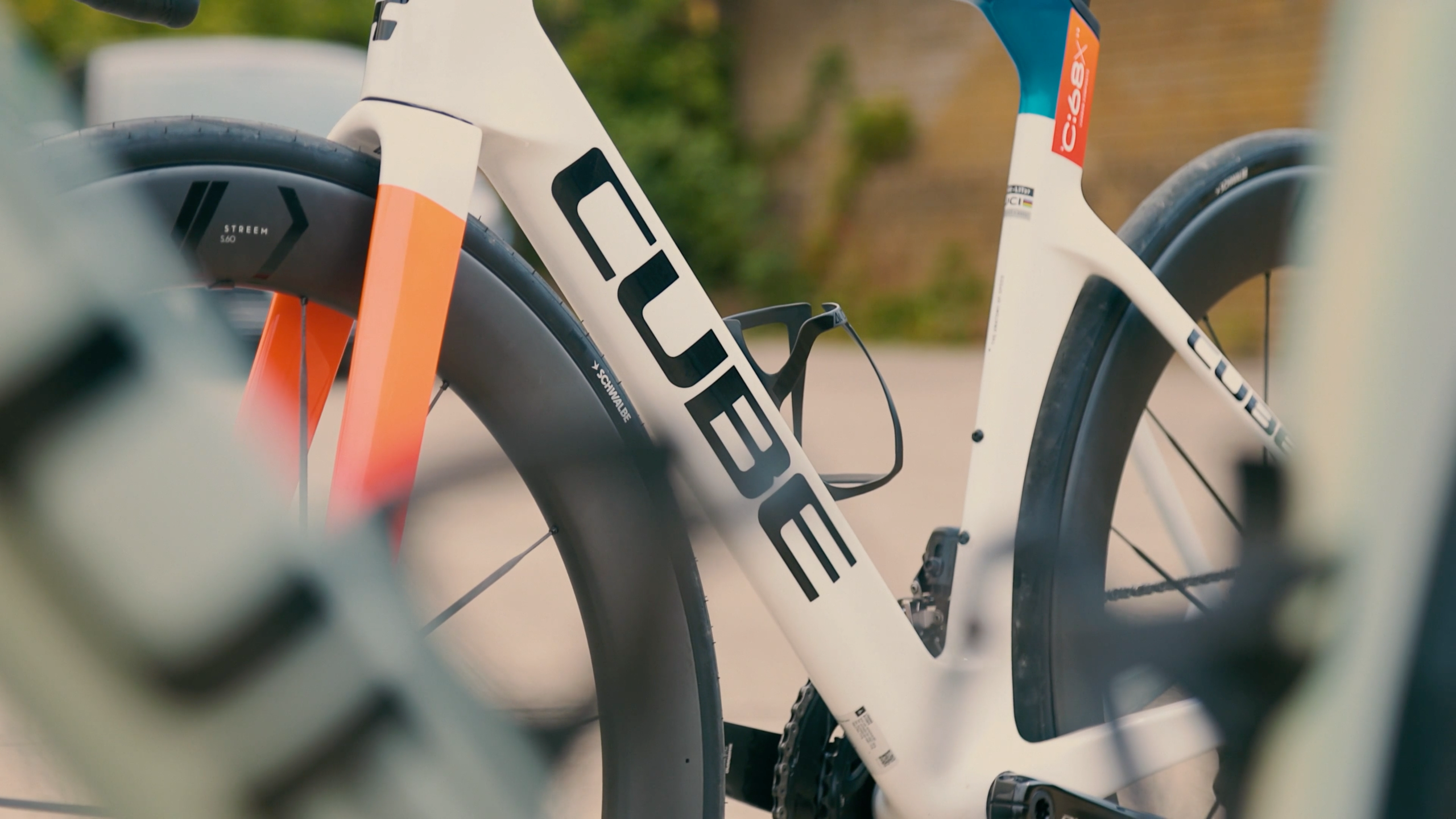 A blue, white and red Cube road bike in an urban environment