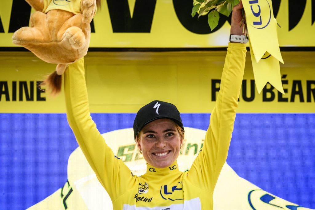 TOPSHOT Team SD Worxs Dutch rider Demi Vollering celebrates on the podium wearing the overall leaders yellow jersey at the end of the eighth and final stage out of 8 of the second edition of the Womens Tour de France cycling race an 226 km individual time trial between Pau and Pau southwestern France on July 30 2023 Photo by Jeff PACHOUD AFP Photo by JEFF PACHOUDAFP via Getty Images