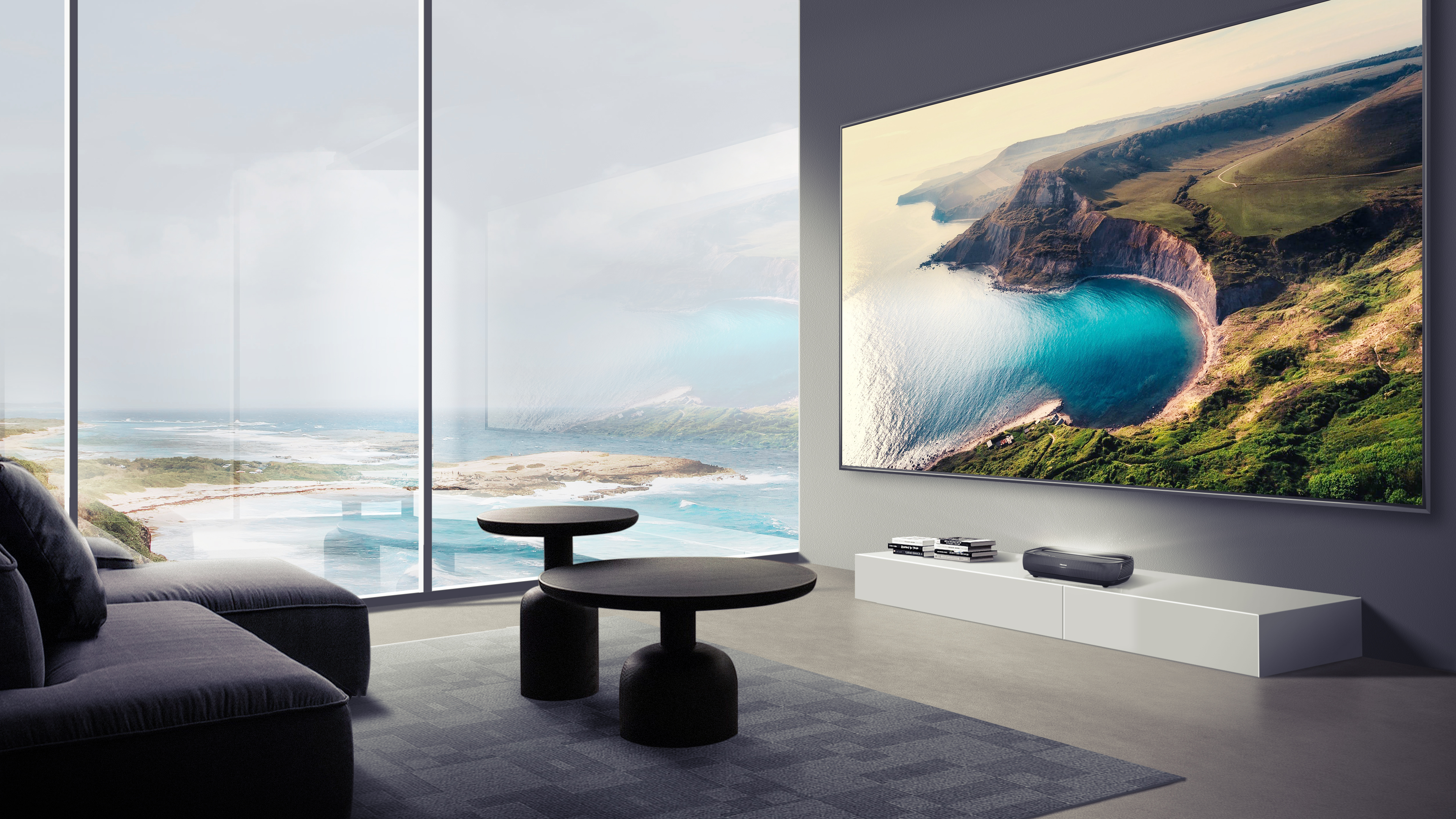 The Hisense L9G hanging in a grey front room with large windows