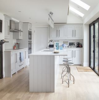 kitchen with white cabinet and wooden flooring