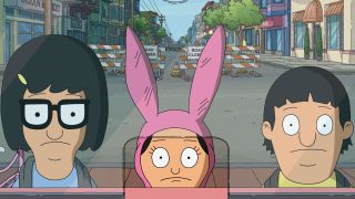 Tina, Louise, and Gene staring through a ticket window in The Bob's Burgers Movie.