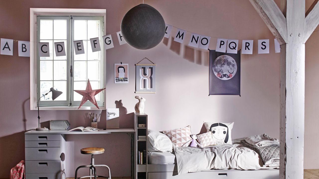 how to design a kid&#039;s room: blush toned kid&#039;s bedroom with alphabet bunting, a single bed, desk and sweet patterned posters and bedding by cuckooland