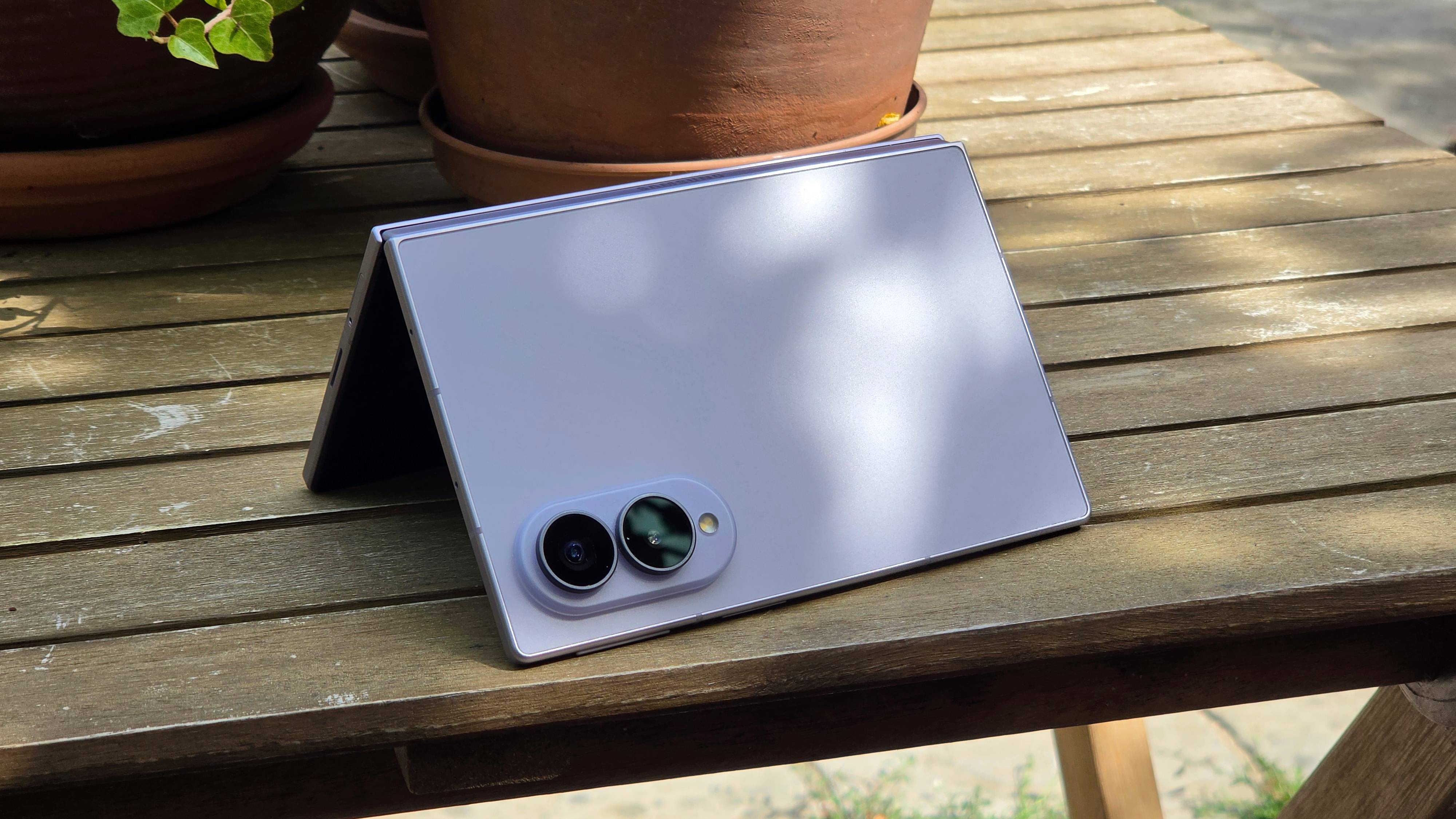 The Samsung Galaxy Z Fold 8 on a wooden table, in an upside-down 'V' shape.