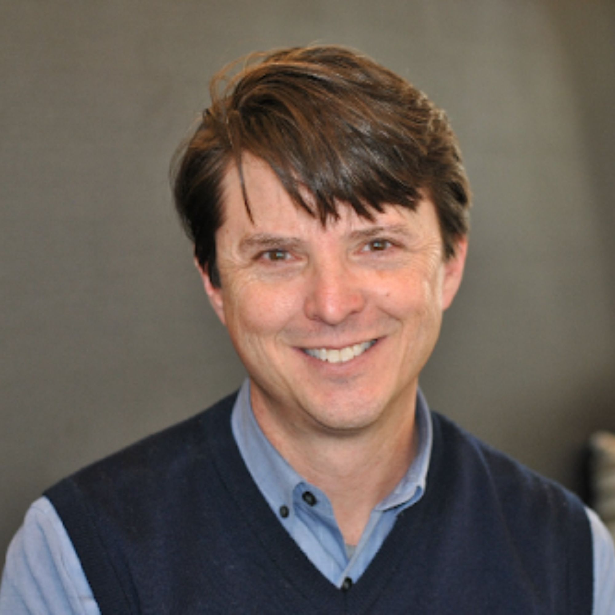 Jason Altshuler smiling in a blue shirt and vest
