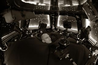 Don Pettit poses during a photography session inside the Cupola on the International Space Station.