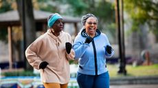 Two women power walking in a park in winter