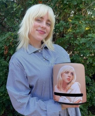 Billie EIlish holding her Amazon Speaker.