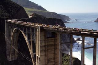 The peloton passes Bixby Bridge in the 2006 Tour of California.