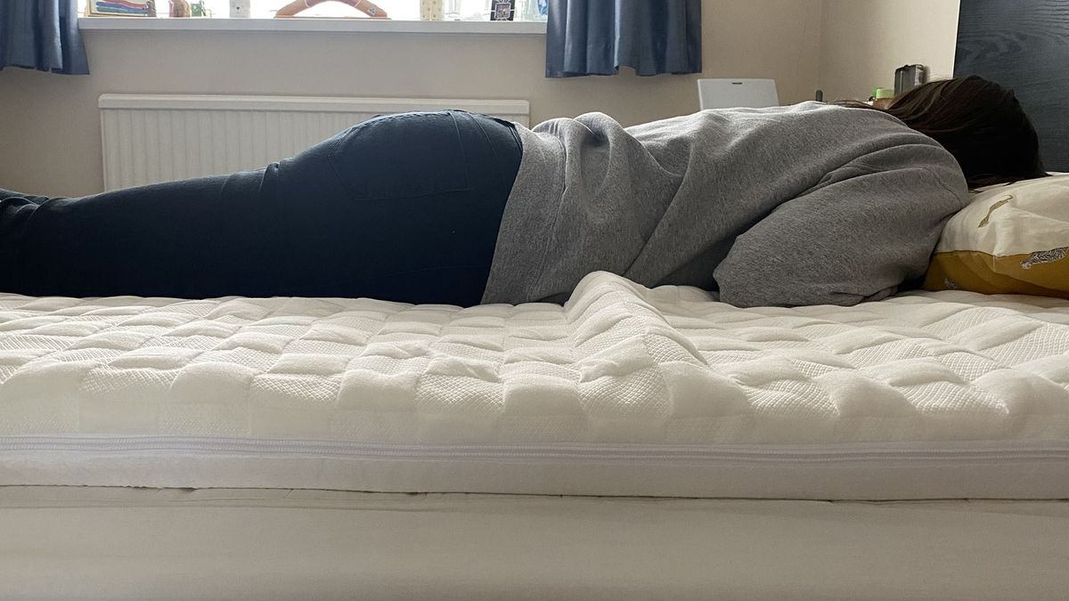 Levitex mattress topper with reviewer lying on her front