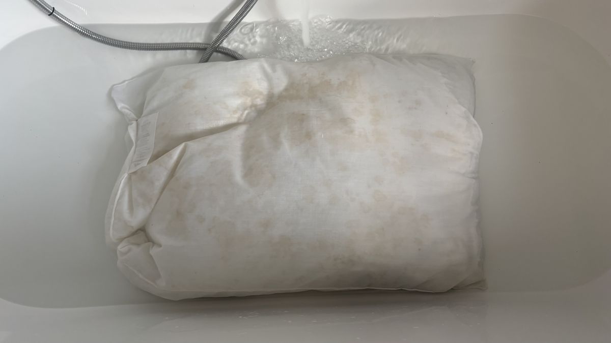 A stained pillow after being soaked on a soda crystal bath.