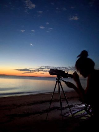 Joy Ng, a multimedia producer at NASA's Goddard Space Flight Center, observes and photographs Comet NEOWISE.