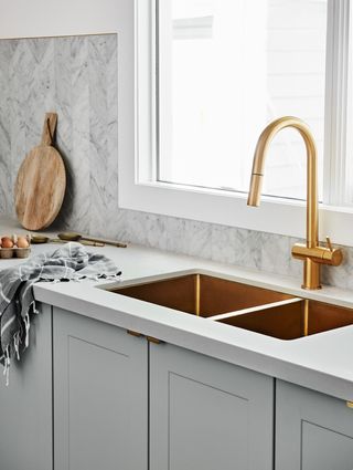 Copper sink in a modern white kitchen