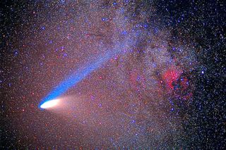 Image of Hale-Bopp streaking across the star-studded sky with a long bright blue tail and a strong bright white tail.