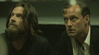 From left to right: Jason Bateman and Jude Law both looking up in Black Rabbit.