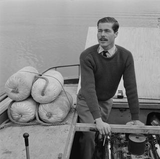 John Bingham, 7th Earl of Lucan working on the engine of his powerboat