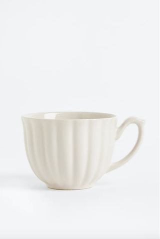 white porcelain teacup with scallop detail