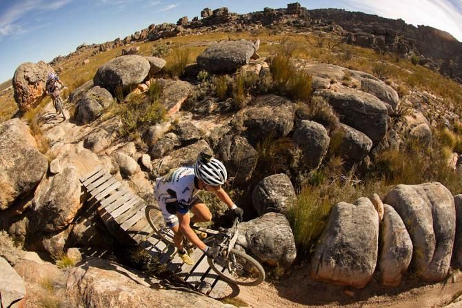Riders cross a bridge