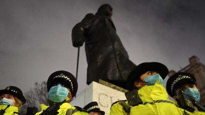 Churchill statue surrounded by police 