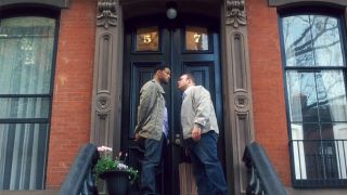 Will Smith and Kevin James stare each other down on the steps of a New York brownstone.