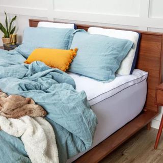 Best mattress topper on wooden bed frame on mattress
