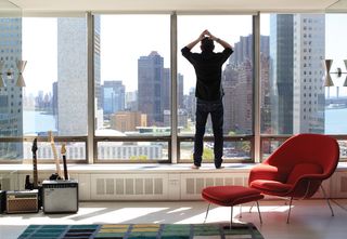 Liam Gillick looking out the window in his home in New York