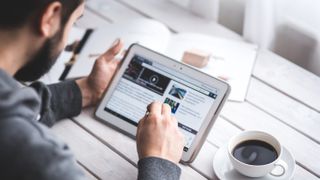 Man studying news on tablet