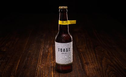 A bottle of &quot;TOAST&quot; beer on dark wood