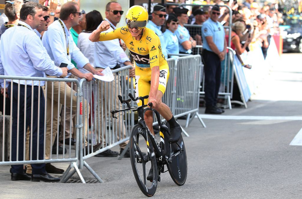 Chris Froome punches the air after his TT win to all but secure a third Tour win on stage 18