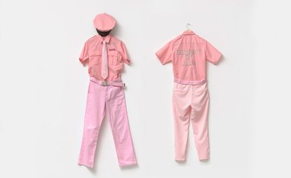 Pink uniforms on wall as part of 'Day Jobs' exhibition at Cantor Arts Center